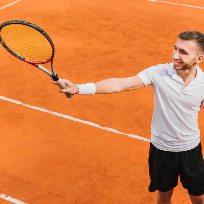 male tennis player happy waving his racket